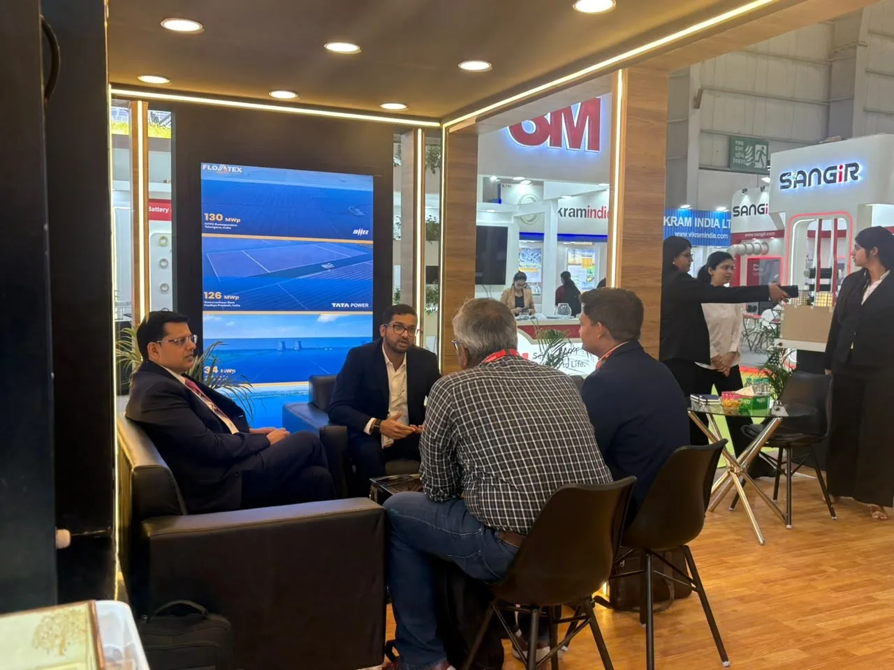 Floatex Solar team in discussion with visitors at the booth, beside displays of 130 MWp and 126 MWp floating solar projects